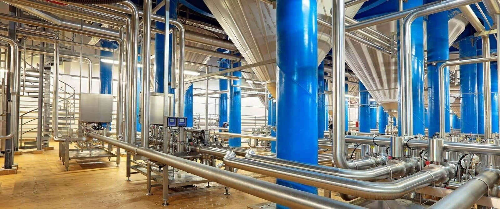 Modern industrial processing facility with stainless steel piping