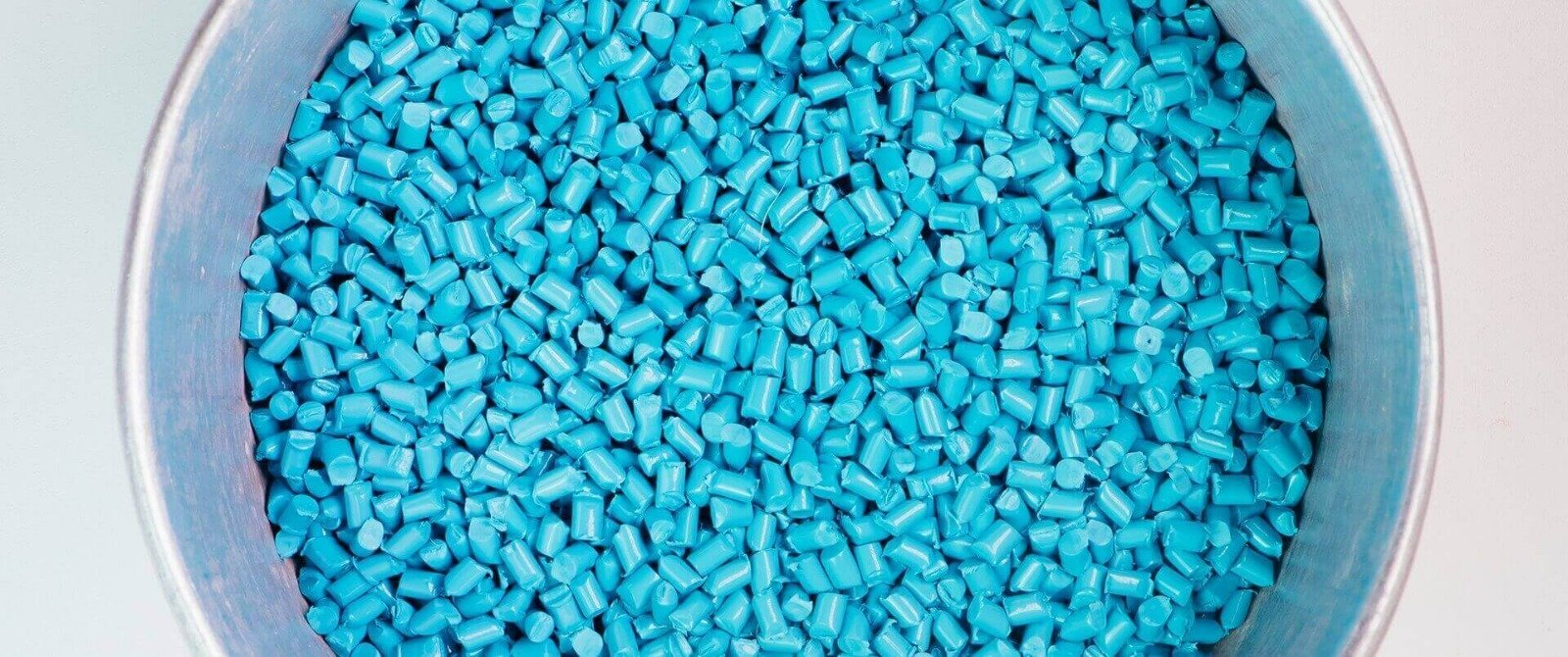 Blue industrial material inside a stainless steel vessel